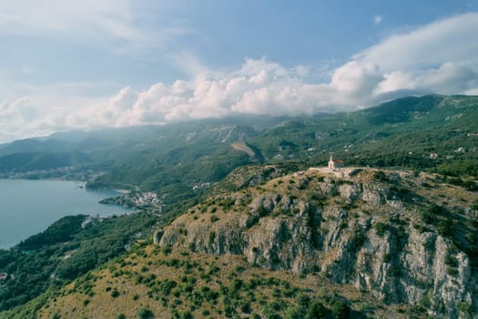 Church of St. Sava at the top of the mountain surrounded by a green mountain range. Montenegro. Drone. High quality photo