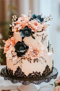 Big pastel gothic cake decorated with pink, blue, white and black elements.