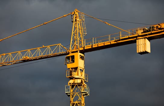 Construction boom in western Ukraine. Sunset light highlights cranes and buildings in a city under development.