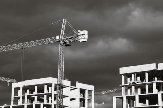 Construction boom in western Ukraine. High-rise buildings under construction, featuring unfinished concrete and brick structures.