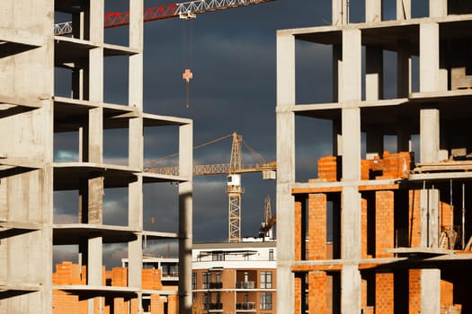 Construction boom in western Ukraine. High-rise buildings under construction, featuring unfinished concrete and brick structures.