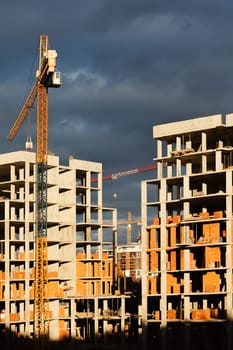 Construction boom in western Ukraine. High-rise buildings under construction, featuring unfinished concrete and brick structures.