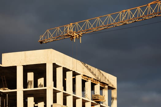 Construction boom in western Ukraine. Sunset light highlights cranes and buildings in a city under development.