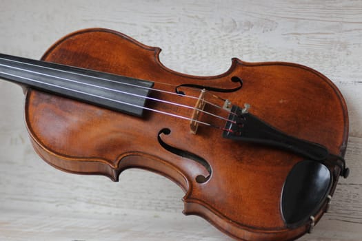 violin - an orchestral or solo professional bowed musical instrument with four strings. loved by children and adults. used in classical folk popular and jazz music. High quality photo