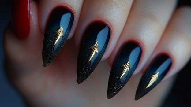 Close-up of a woman's hand with bold, dark manicure featuring long, stiletto-shaped nails. the nails are adorned with gold arrow designs, creating an edgy and fashion-forward look, suitable for trendsetting nail art enthusiasts.