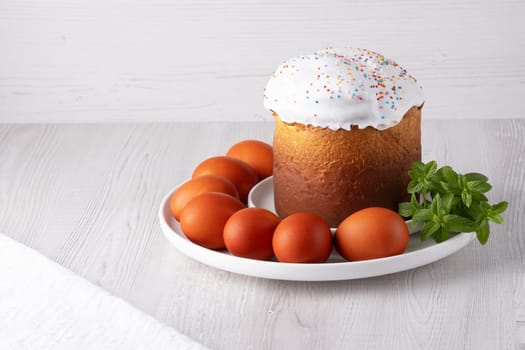 Delicious Easter cake and eggs on light background, with copy space for text.