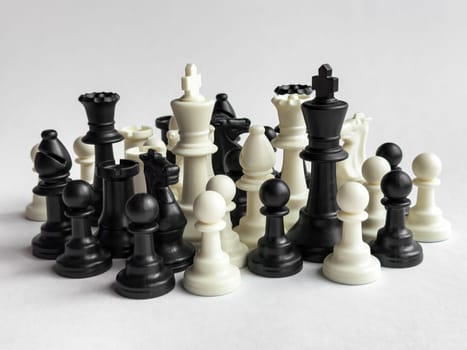 Abstract chess pieces arrangement on light background.