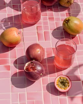 Refreshing passion fruit and apple drinks arranged on a pink tiled surface.