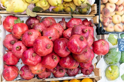 pomegranate organic red juicy background fruit healthy fresh ripe food vegetarian market closeup