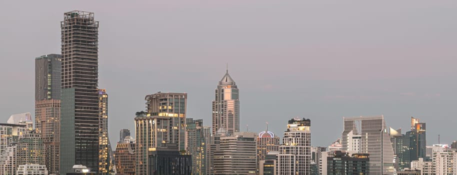 Bangkok, Thailand - 31 Dec, 2022 - Panorama viewed of Bangkok downtown cityscape in Business district with bright glowing lights at night. City night view of Bangkok city skyscrapers after sunset, Space for text, Selective Focus.