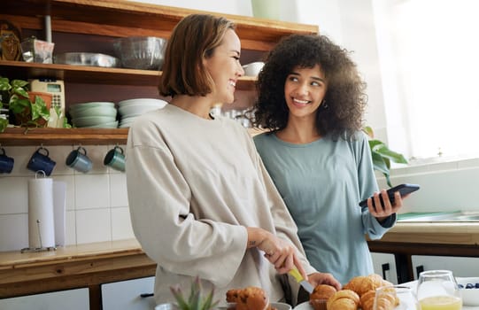 Lesbian, couple and women with phone and cooking with happiness in kitchen for breakfast and nutrition in morning. Food, people and smile with romance in home or face for wellness, lgbt or love.