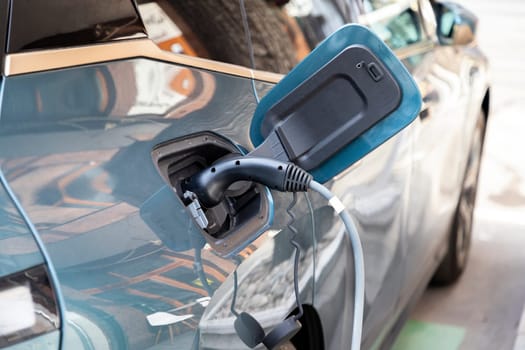 Close up of power supply plugged into an electric car being charged for hybrid 