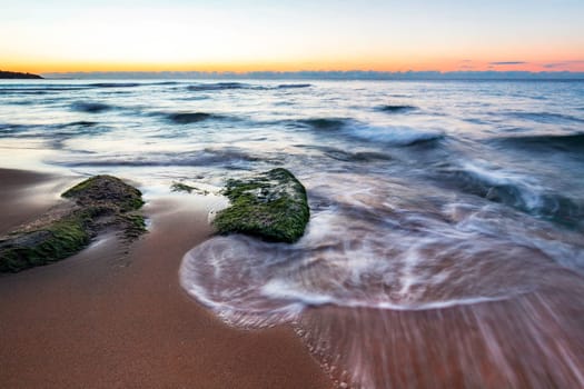 Exciting long exposure sunrise over the sea.