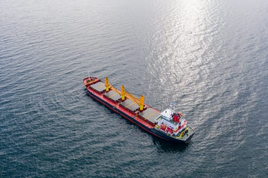 Aerial top view of cargo ship vessel import export sailing.