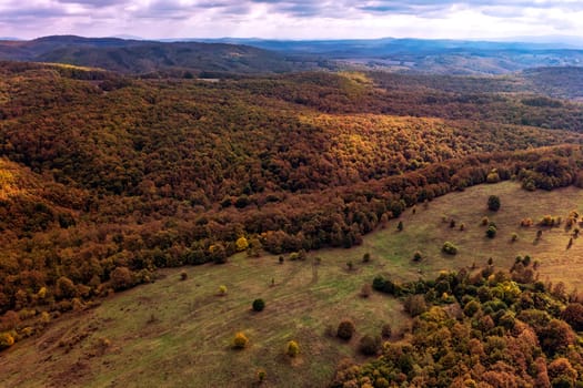 aerial view of mountain and valley  covered with autumn colors