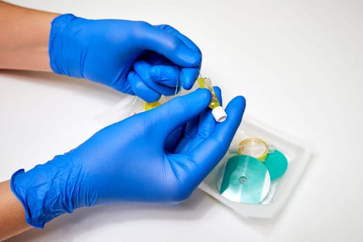 Preparation for epidural anesthesia. Epidural anesthesia kit and medical professional's hands in protective gloves close-up