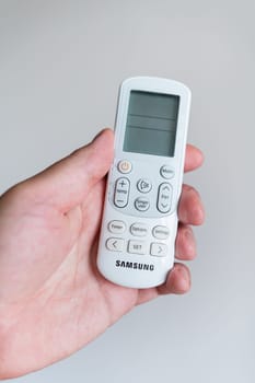 Close-up of the remote control for controlling the air conditioner. The concept of fresh air in an apartment or private house