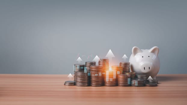 Piggy bank and coins lined up on wooden floor with candlesticks and arrows on a white background. Concepts of finance, savings and investment.