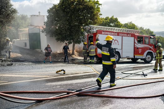 Portugal, Odivelas 07 September 2022 Rescue Team of Firefighters Arrive on the Car Crash fired passenger bus Traffic Accident Scene. Firemen fire department fight with fire on road. Accident disaster