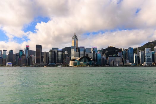 Hong Kong, September 8, 2023: Clouds and blue sky over modern city skyline by Victoria Harbor. High quality photo