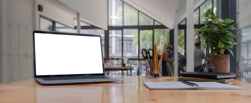 modern laptop computer with blank screen at workplace in office. finance report and calculator accounting on wooden table.