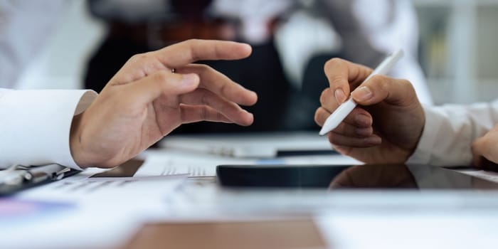 Woman hand holds stylus and puts an electronic signature in contract on tablet.