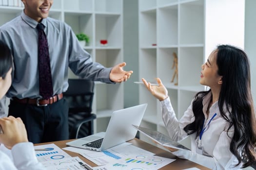 Young woman office worker smile and talk about analyzing strategies with colleague.