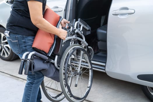 Asian disability woman on wheelchair getting in her car, Accessibility concept.