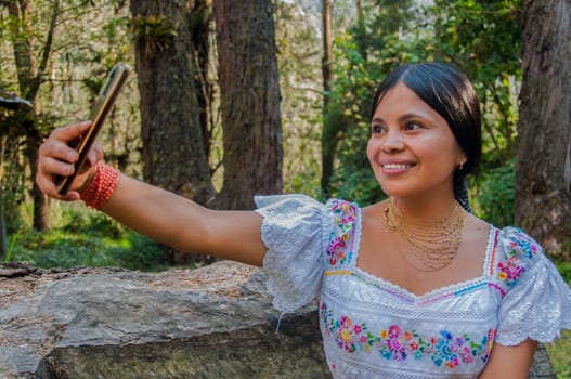 In the heart of Ecuador's lush rainforest, an indigenous gem shines brightly, capturing the spirit of a vibrant culture while striking a pose in this stunning selfie. High quality photo