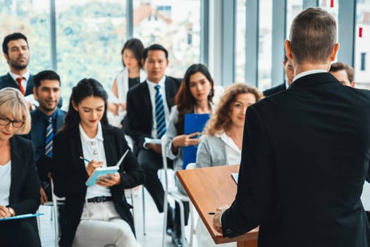 Group of business people meeting in a seminar conference . Audience listening to instructor in employee education training session . Office worker community summit forum with expert speaker . Jivy