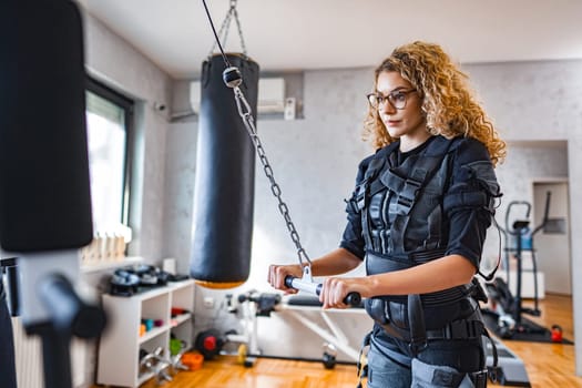 A person works out with advanced muscle stimulation technology.