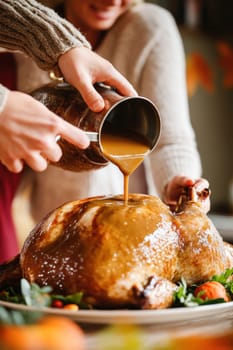 Two chefs pouring gravy on a roasted turkey garnished with herbs and vegetables, preparing for thanksgiving dinner