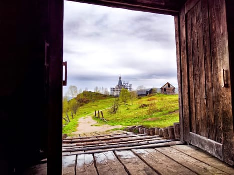 The historic wooden church stands as a filming backdrop in the Perm Region, capturing a peaceful landscape during movie production.