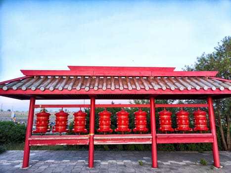Kalmykia, Russia - April 22, 2024: Colorful prayer wheels adorn the temple of the Golden Buddha in Elista, Kalmykia, inviting visitors to partake in spiritual rituals.