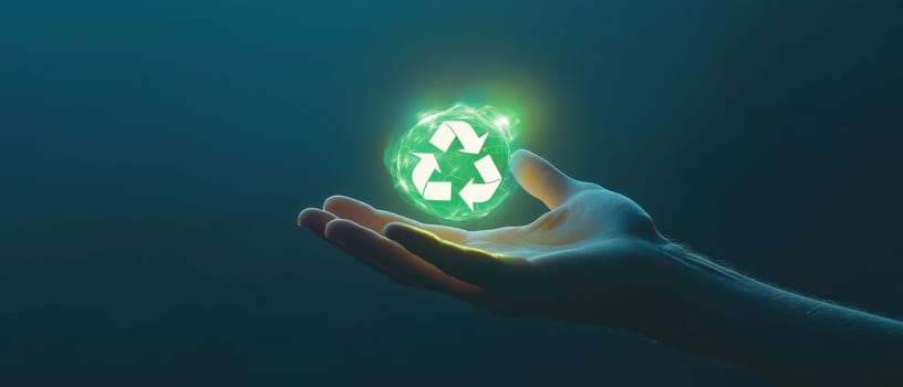 A hand holds a glowing recycle symbol against a dark backdrop, symbolizing sustainability and environmental responsibility. This image embodies hope.