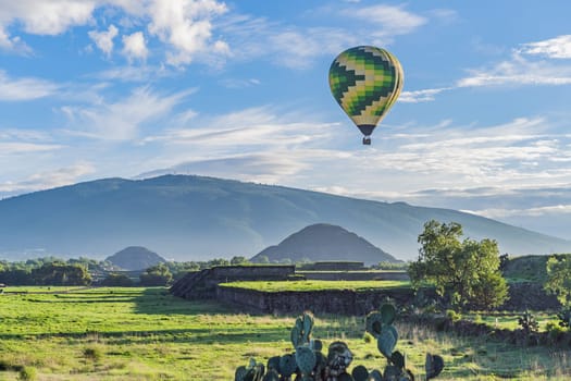 An aerial view of hot air balloons above the Teotihuacan pyramid. Adventure travel, cultural heritage, and aerial exploration concept.