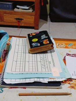 A vibrant desk setup featuring notebooks, pens, and creative supplies. A colorful pencil case and decorative journal indicate a fun and organized workspace. Ideal for studying or creative projects.