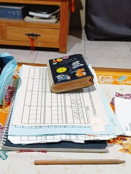 A vibrant desk setup featuring notebooks, pens, and creative supplies. A colorful pencil case and decorative journal indicate a fun and organized workspace. Ideal for studying or creative projects.