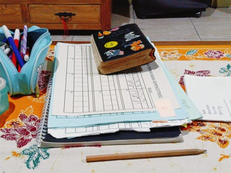 A vibrant desk setup featuring notebooks, pens, and creative supplies. A colorful pencil case and decorative journal indicate a fun and organized workspace. Ideal for studying or creative projects.