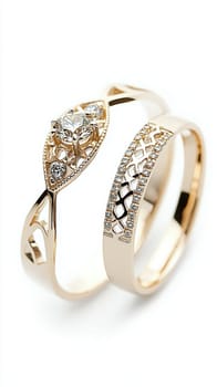 Two simple gold wedding rings are laying on white cloth, ready for the couple to exchange during their wedding ceremony