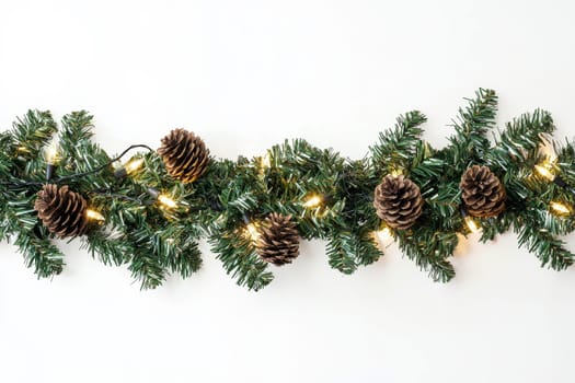 green garland with lights and pine cones on isolated white background..