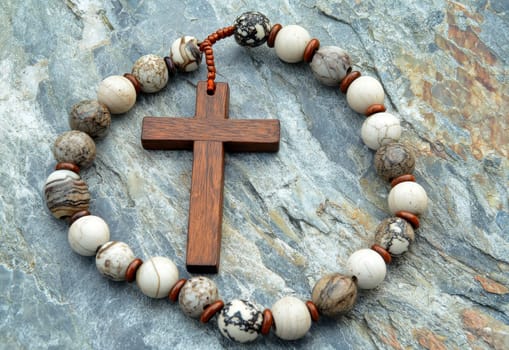 Rosary with wooden cross on stone background --ar 3:2 --quality 2 --v 6.1 Job ID: 3f05c3b4-5bf6-426a-8a5f-0040e99dd278