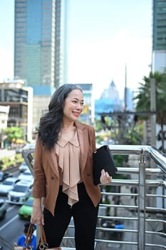Portrait of successful mature businesswoman enjoying the city landscape.