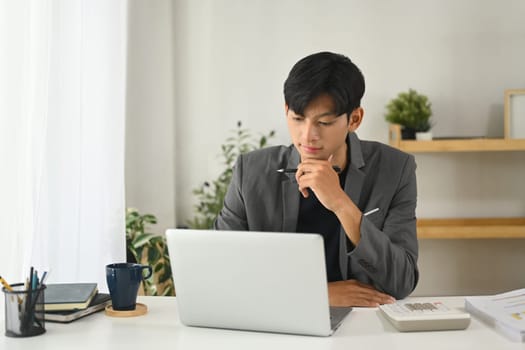 Professional businessman concentrating on work in a modern office.