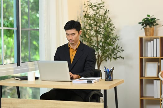 Professional businessman concentrating on work in a modern office.