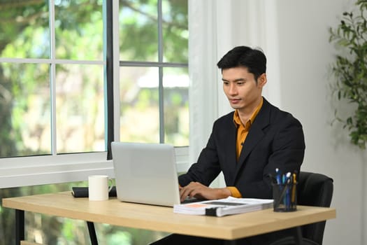 Professional businessman concentrating on work in a modern office.