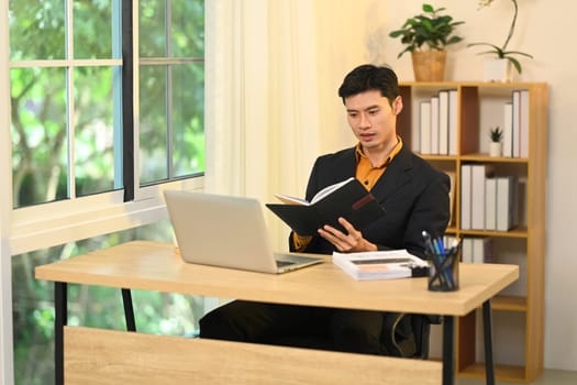 Professional businessman concentrating on work in a modern office.