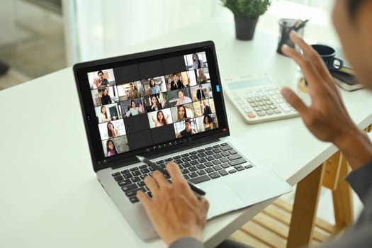 Businessman participating in online team meeting via video chat.