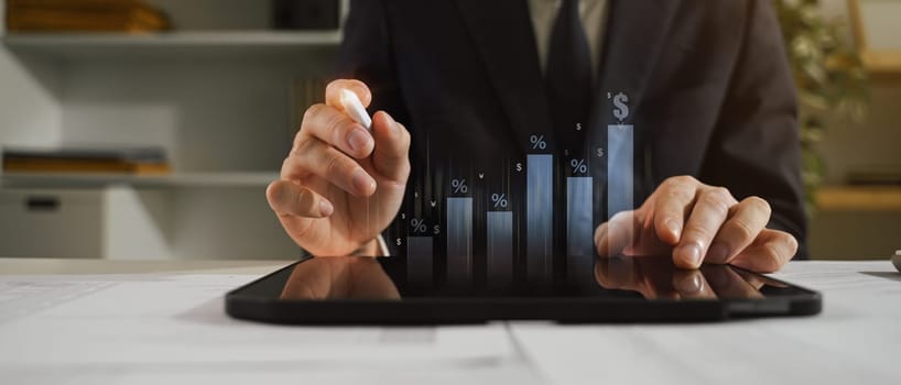 Professional businessman monitoring market growth with digital interface.