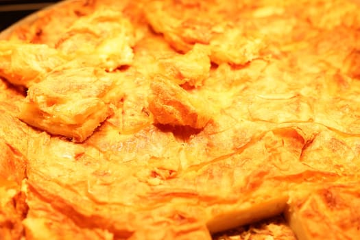 A close-up of a golden-brown baked dish, showcasing its crispy texture and mouthwatering appearance.